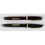 Two fountain pens with gold nibs,