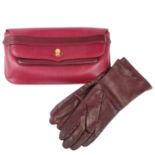 CARTIER - a Bordeaux leather clutch and a pair of leather gloves.