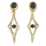 A pair of onyx and diamond drop clip earrings.