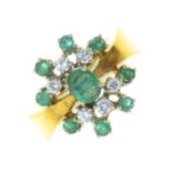 An 18ct gold emerald and diamond cluster ring.