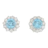 A pair of zircon and diamond cluster earrings.