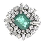 An emerald and diamond cluster ring.