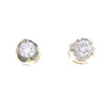 A pair of brilliant-cut diamond stud earrings.