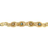 A split pearl and blue gem bracelet.