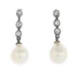 A pair of early 20th century diamond and pearl earrings.