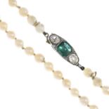 A cultured pearl necklace with emerald and diamond clasp.