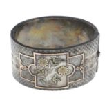 A late 19th century silver hinged bangle.