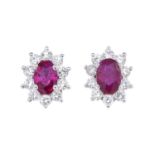 A pair of ruby and diamond cluster earrings.