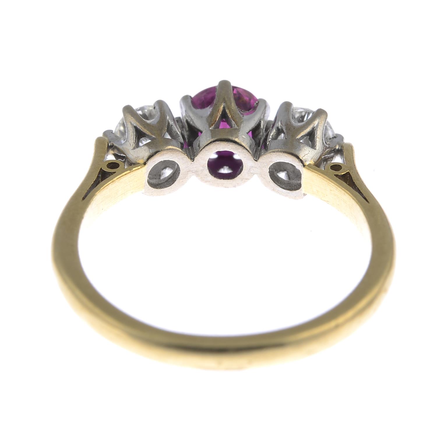 An 18ct gold ruby and diamond three-stone ring. - Image 3 of 3