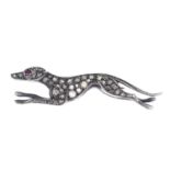 A ruby and diamond dog brooch.