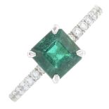 An emerald and diamond ring.