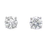 A pair of brilliant-cut diamond stud earrings.