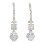 A pair of diamond earrings.