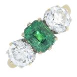 An emerald and diamond three-stone ring.