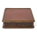 An oak table top cabinet with cloth top,