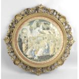 A late 19th century carved giltwood and plaster circular picture frame of pierced shell form,