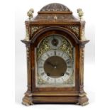 An early 20th century walnut cased bracket style mantel clock,