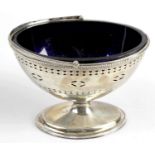 A George III silver sugar basket with blue glass liner,