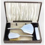 A 1930's cased silver and enamel part dressing table set,