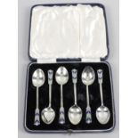 A mid-twentieth century cased set of six silver and enamel teaspoons,