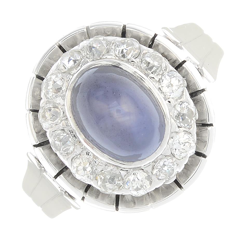 A star sapphire and diamond cluster ring.