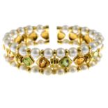 A cultured pearl and gem-set bangle.