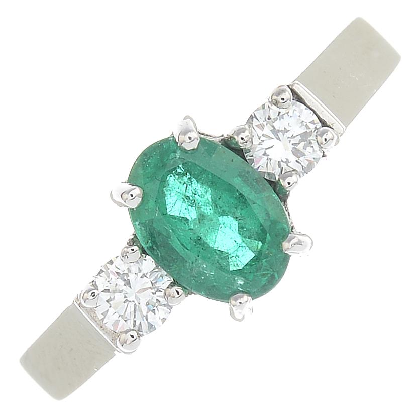 An 18ct gold emerald and diamond three-stone ring.