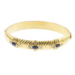 A sapphire and diamond bangle.