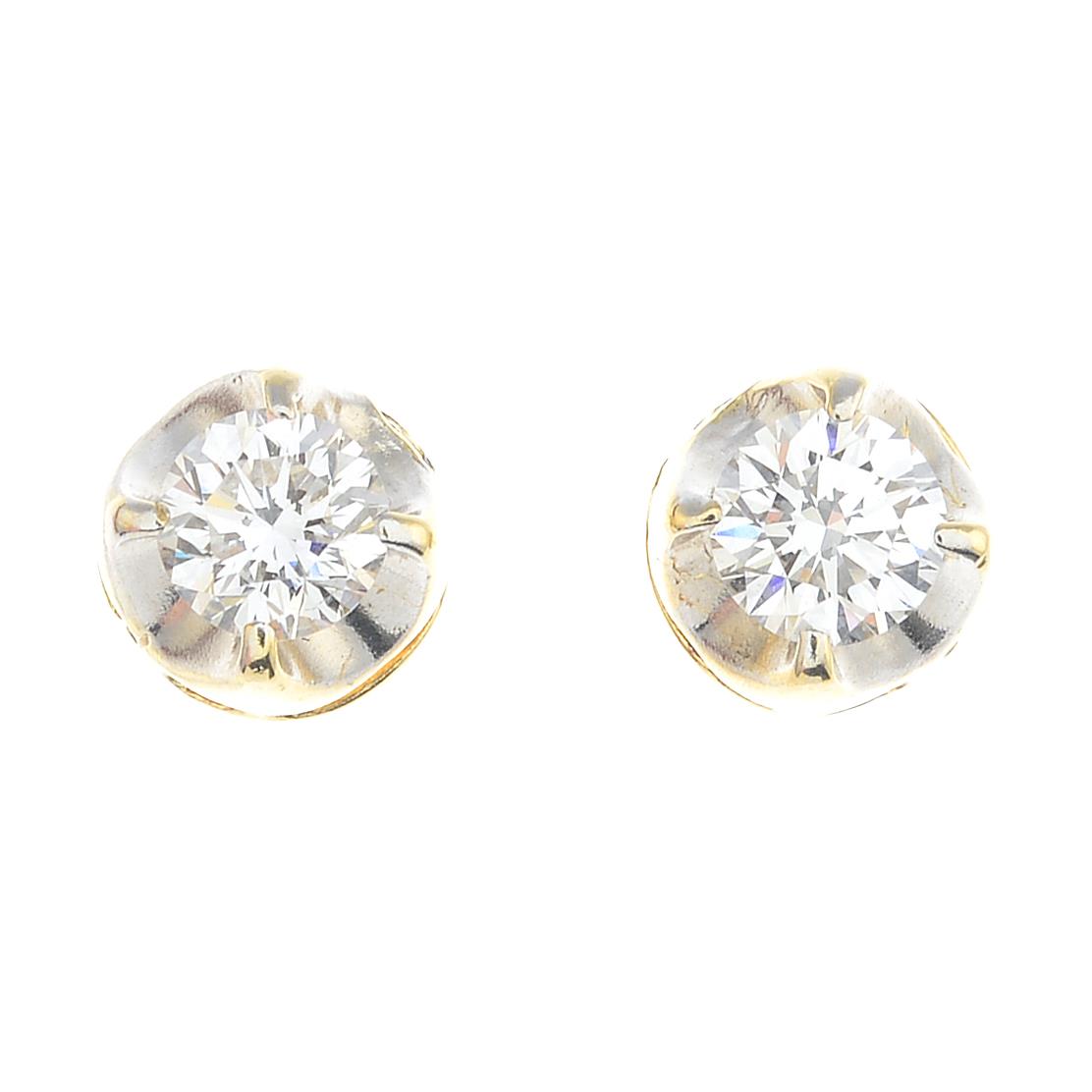 A pair of brilliant-cut diamond stud earrings.