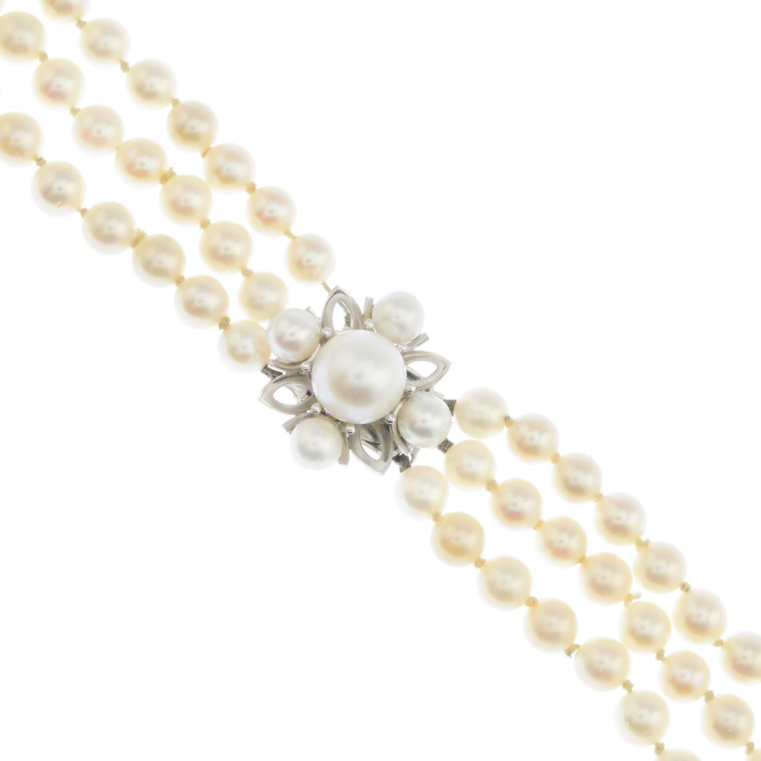 A cultured pearl three-row necklace.