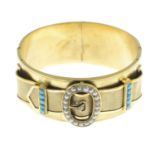 A late Victorian gold, gem-set hinged bangle.