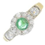 An emerald and diamond cluster ring.