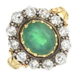 An emerald and diamond cluster ring.