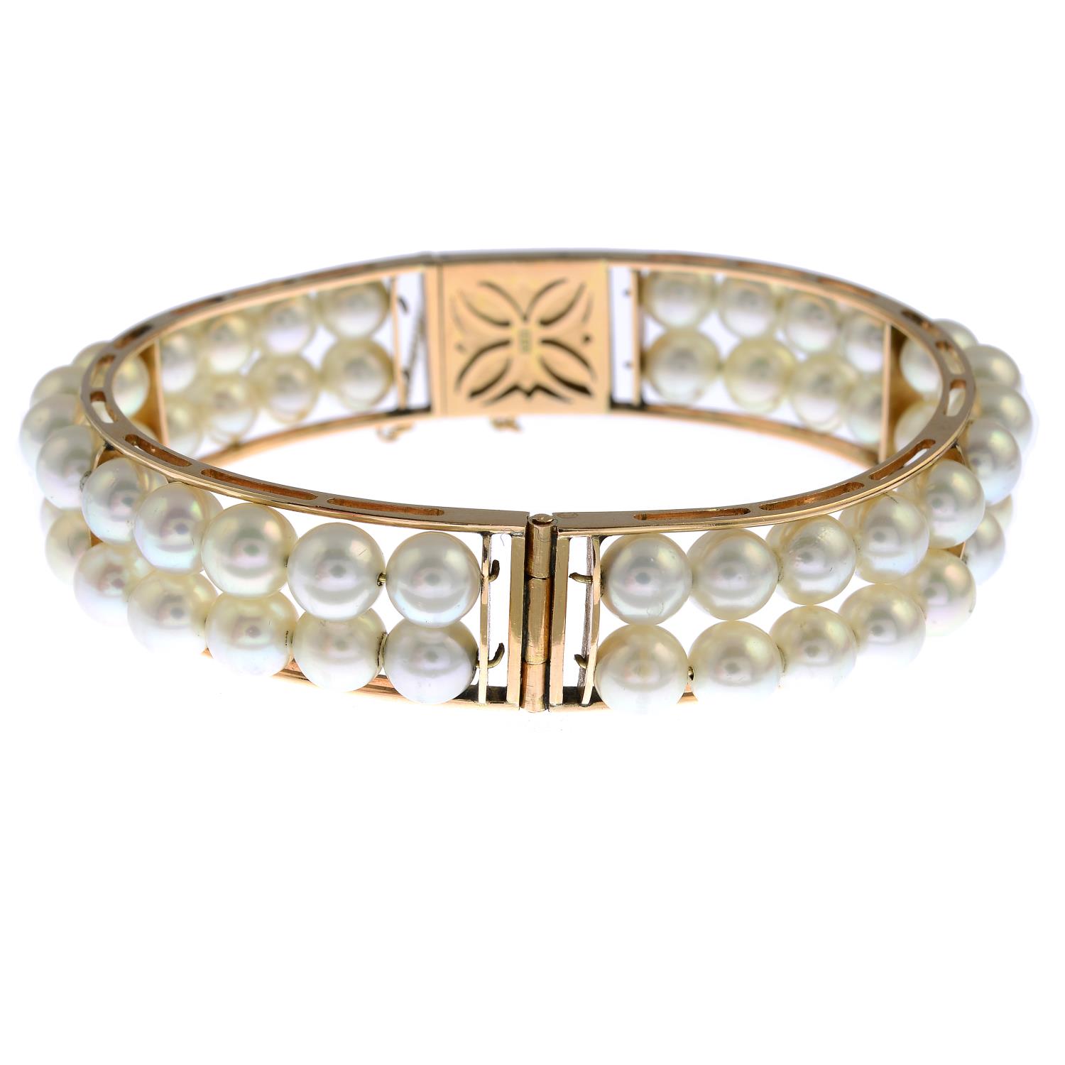 A cultured pearl hinged bangle.