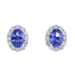 A pair of sapphire and diamond cluster earrings.