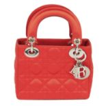 CHRISTIAN DIOR - a red satin Cannage Mini Lady Dior handbag.