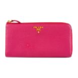 PRADA - a pink zip around wallet.