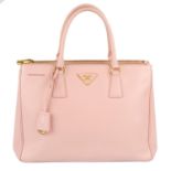 PRADA - a pink Saffiano leather handbag.