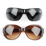 Two pairs of designer sunglasses.