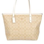 COACH - a Signature City Zip Tote handbag.