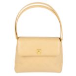 CHANEL - a beige leather handbag.