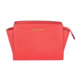 MICHAEL KORS - a coral pink Selma crossbody handbag.