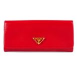 PRADA - a red Saffiano continental wallet.