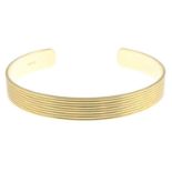 An 18ct gold 'Whip' bangle, by Theo Fennell.