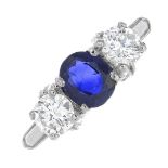 A three-stone ring, set with sapphire and diamonds.