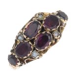 A mid Victorian ring, set with garnets and split pearls, with a later 9ct gold replacement band.