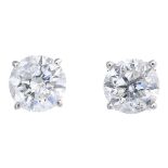 A pair of brilliant-cut diamond stud earrings.