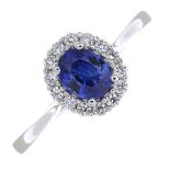 A sapphire and diamond cluster ring.Sapphire weight 0.67ct,