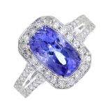 A tanzanite and diamond cluster ring.Estimated total diamond weight 0.30ct.Stamped 14k.