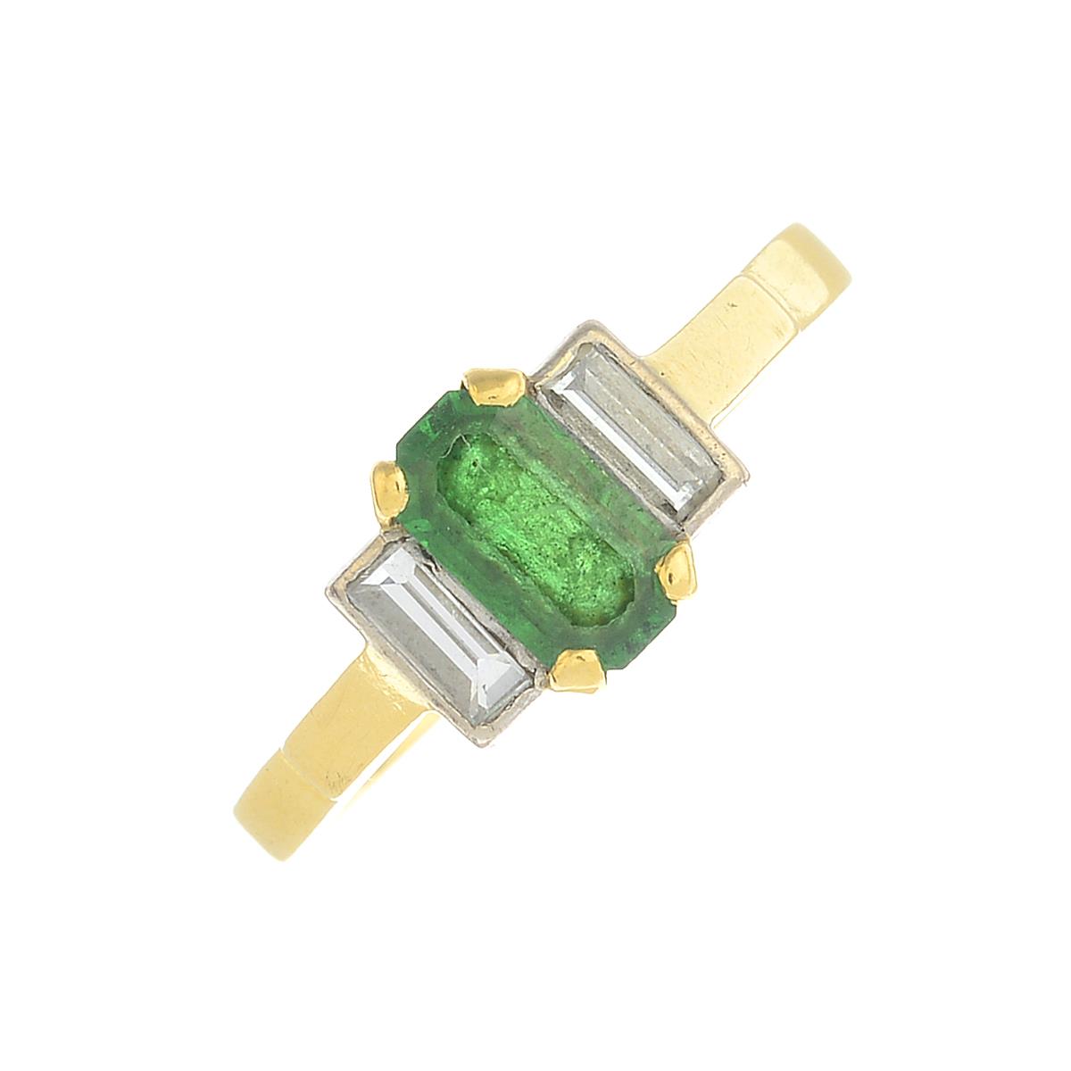 An 18ct gold emerald and diamond three-stone ring.